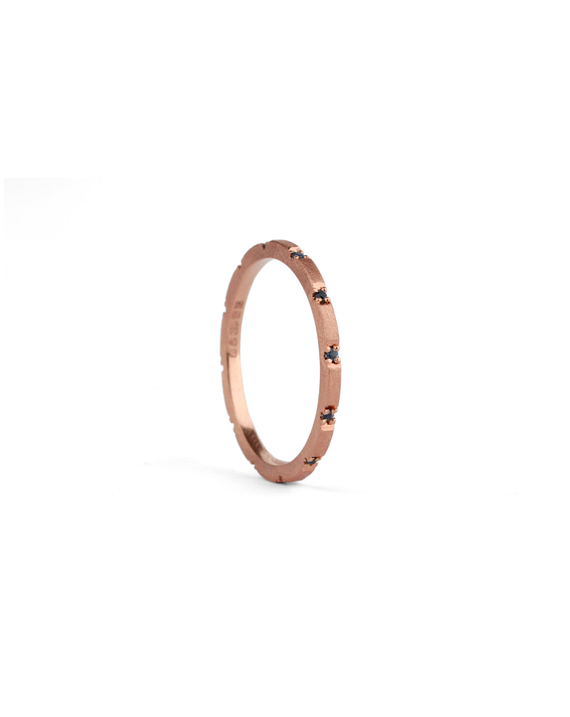 Fine band with set with small dark blue sapphires. 18ct rose gold textured finish.