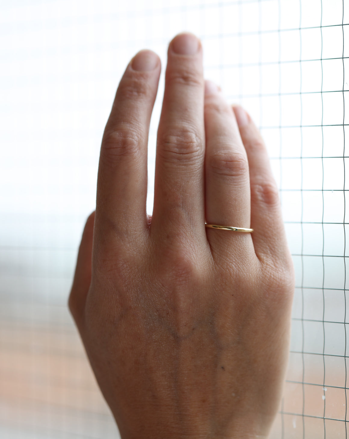 Rounded wedding band. 18ct yellow gold, polished finish. On hand.