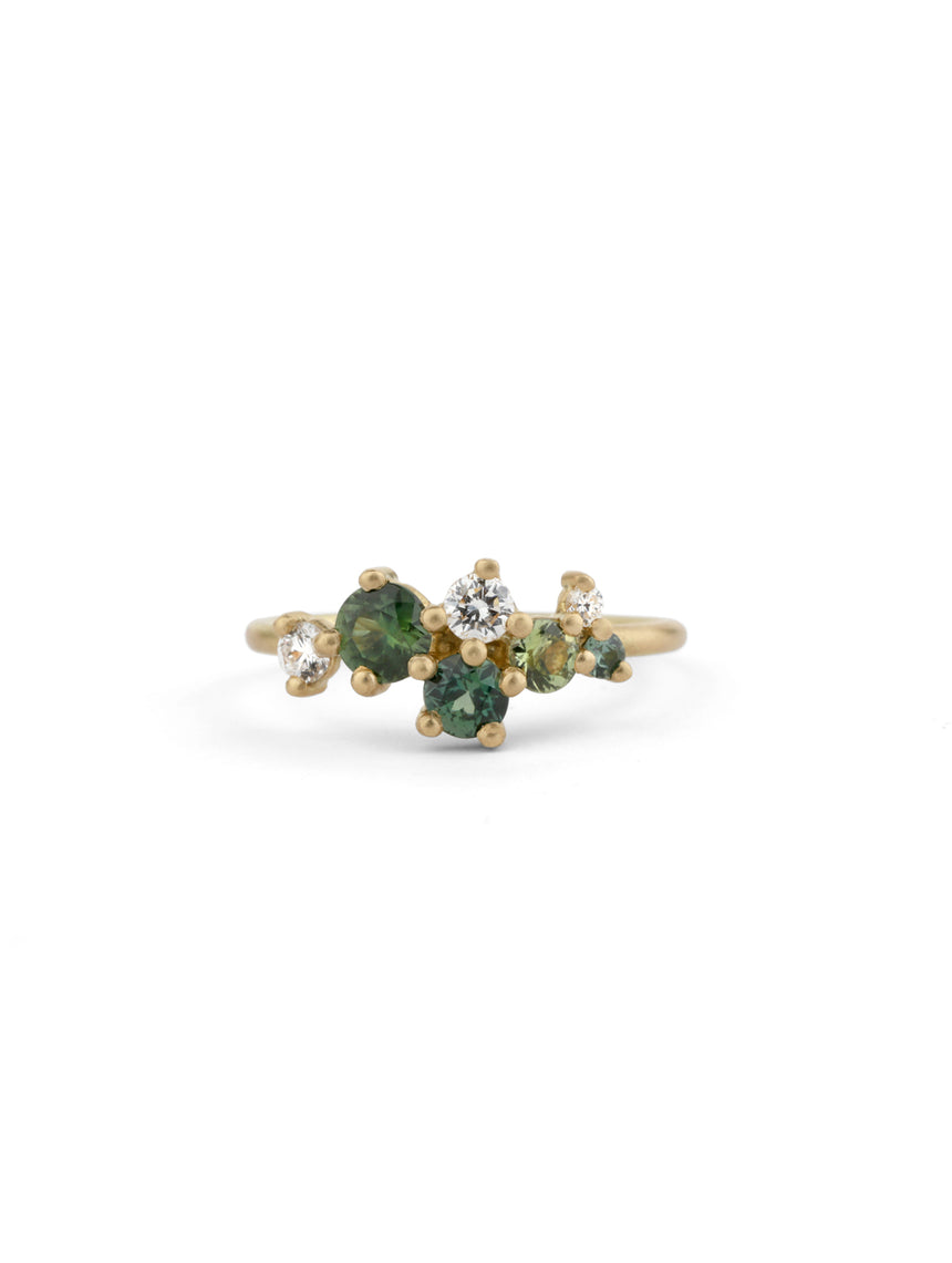 Asymmetric cluster style ring with green sapphires and white diamonds. 18ct yellow gold, satin finish.