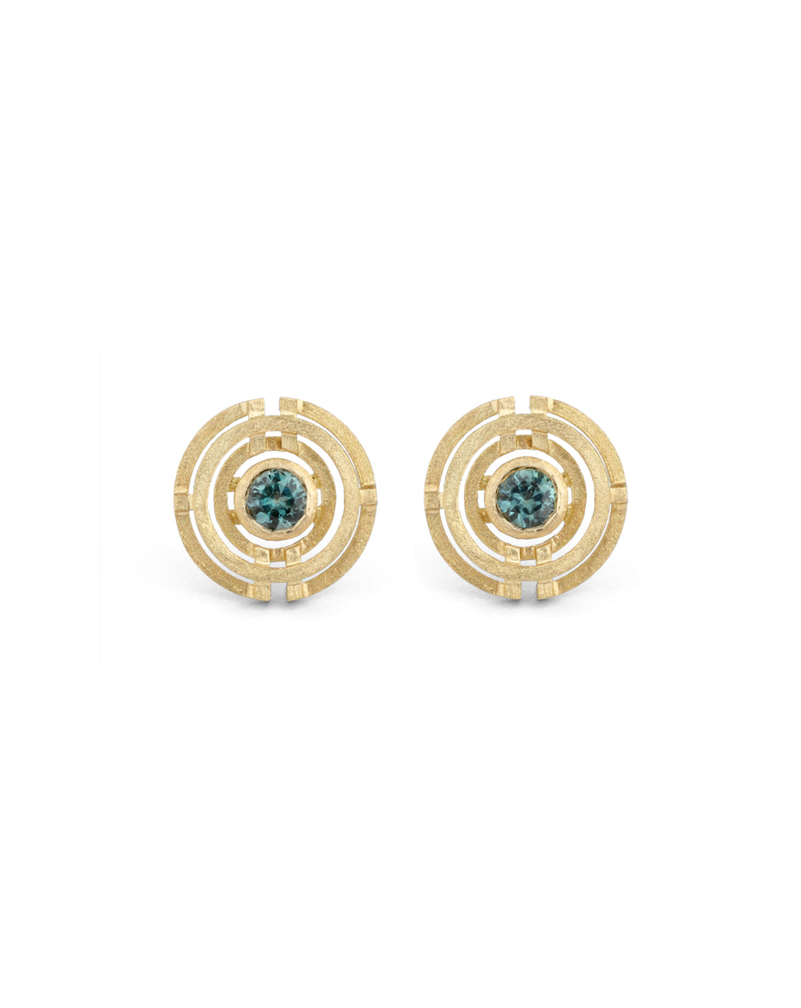 Geometric earrings with concentric circles and central teal sapphires. 18ct yellow gold, textured finish.