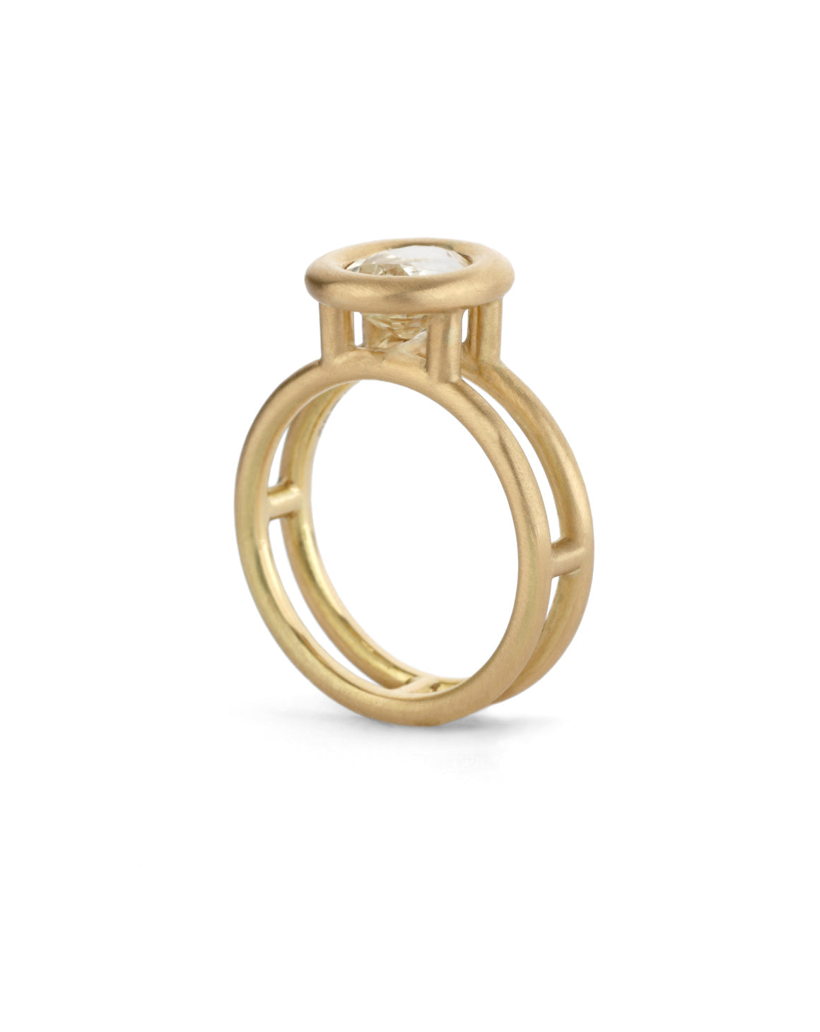 Oval pale yellow sapphire ring with a heavy rounded bezel setting and double band. 18ct yellow gold, satin finish. Side profile.