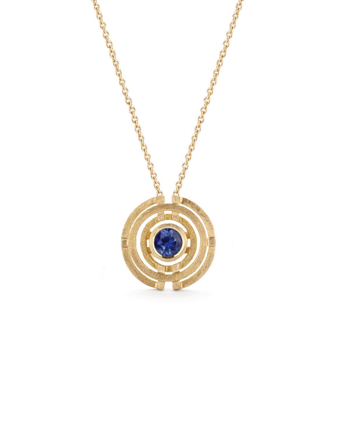 Geometrically patterned pendant featuring a central blue sapphire. Textured 18ct yellow gold.