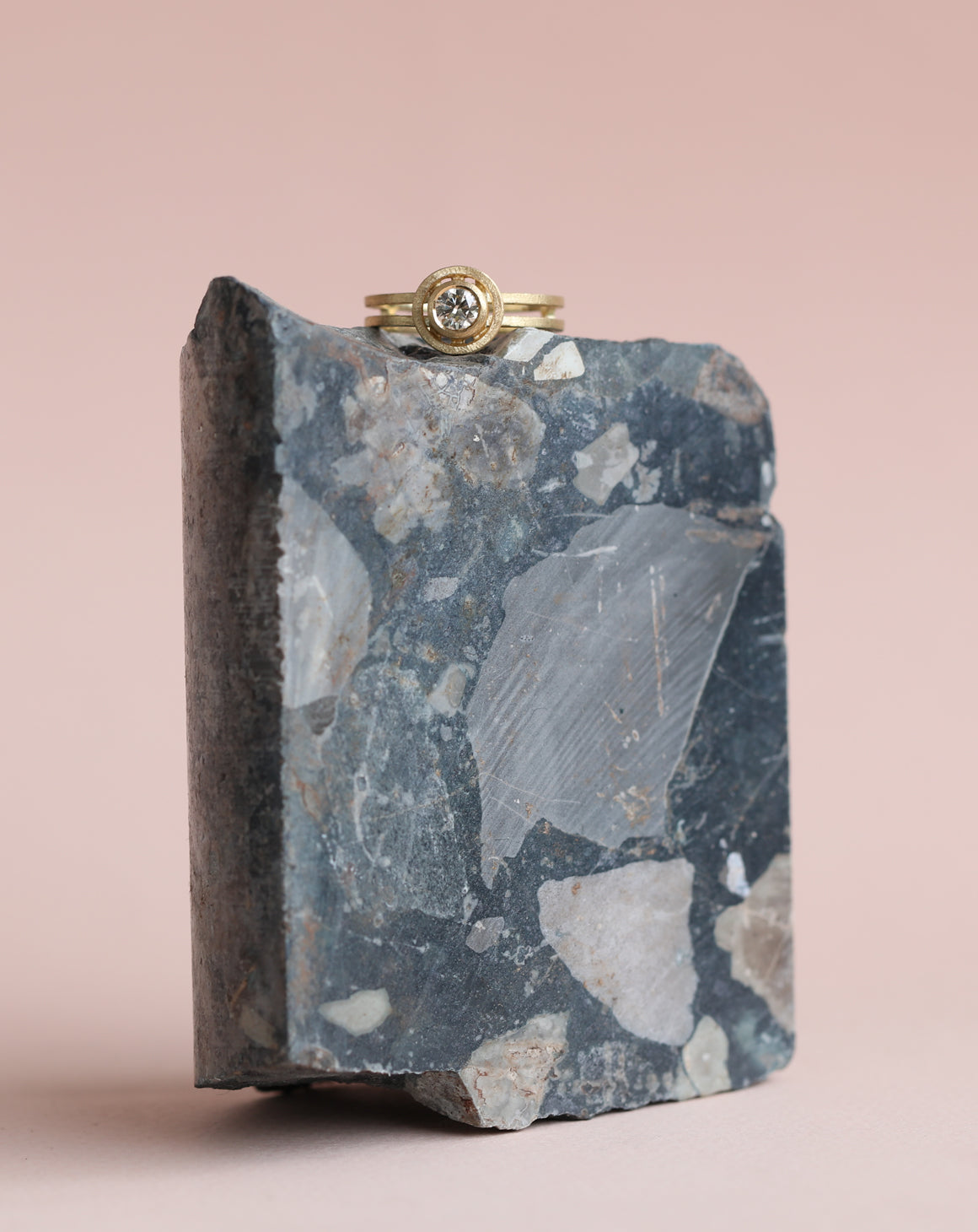 Round champagne diamond ring with circular detail and double band. 18ct yellow gold, textured finish. On rock.