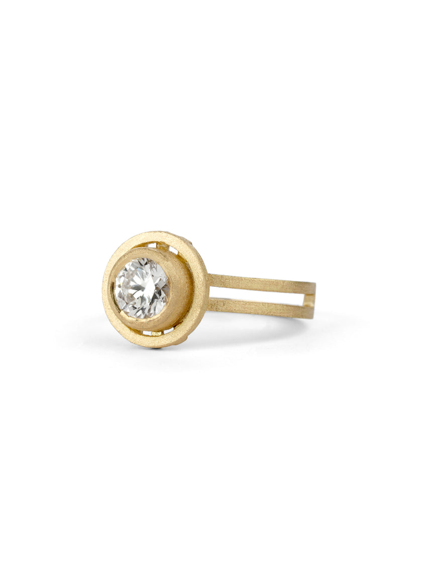 Geometric solitaire ring with circular detail and double band. 18ct yellow gold, textured gold. Side view.