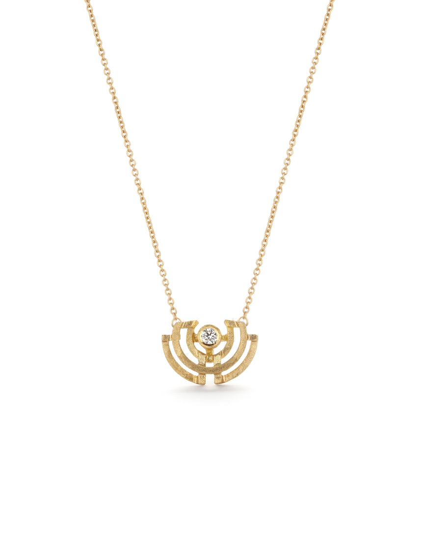 Geometric pendant with semicircle detail, set with a white diamond. 18ct yellow gold, textured finish.