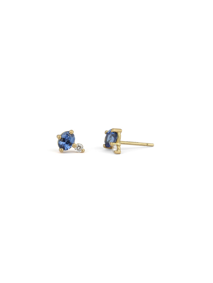 Stud earrings set with oval blue sapphires and white round diamonds. Simple claw setting 18ct yellow gold.