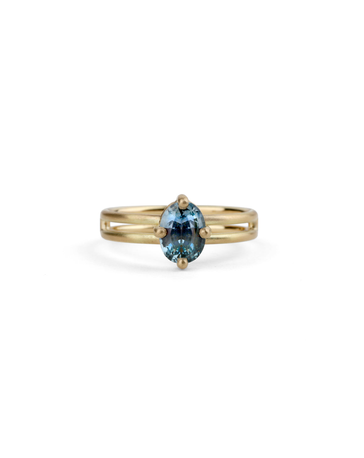 Steely blue oval sapphire ring. Four claw solitaire setting and double band, 18ct yellow gold satin finish,