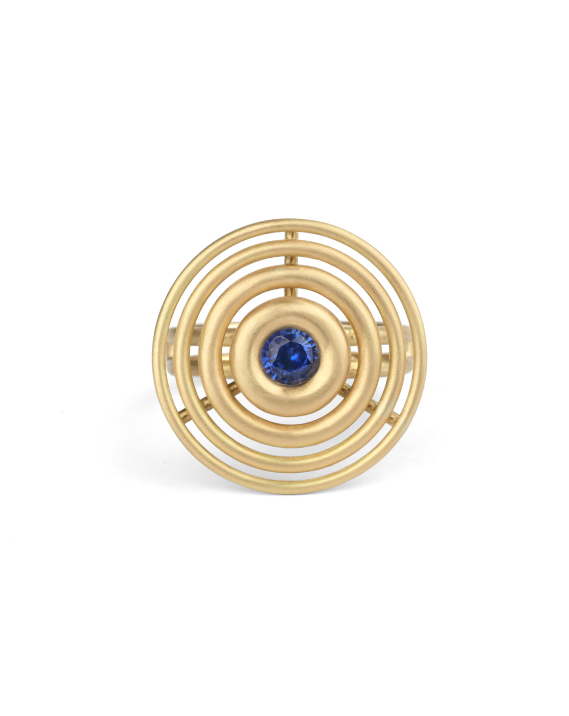 Statement ring made from concentric circles. Central blue sapphire surrounded by 18ct yellow gold rings.