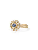 Blue sapphire ring with diamond halo detail. Textured 18ct yellow gold. Side view.