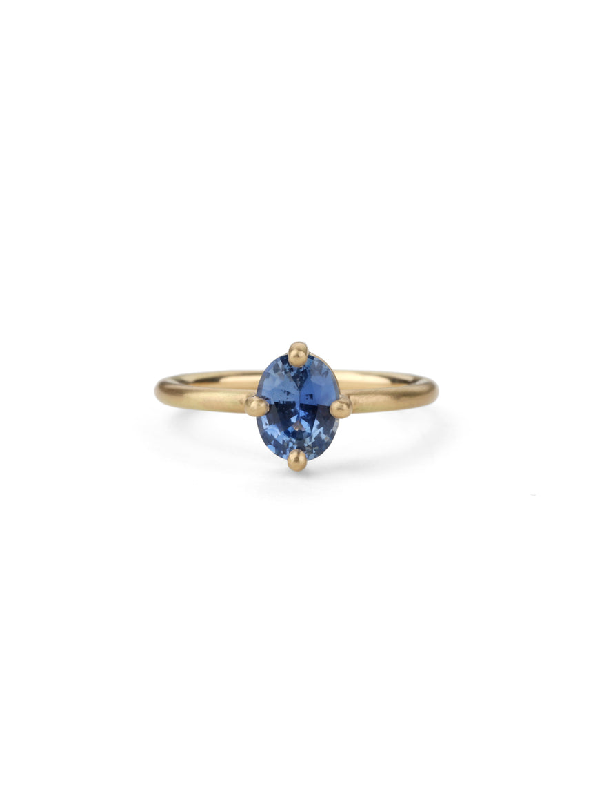 Oval blue sapphire ring, solitaire four claw setting. 18ct yellow gold with a satin finish.