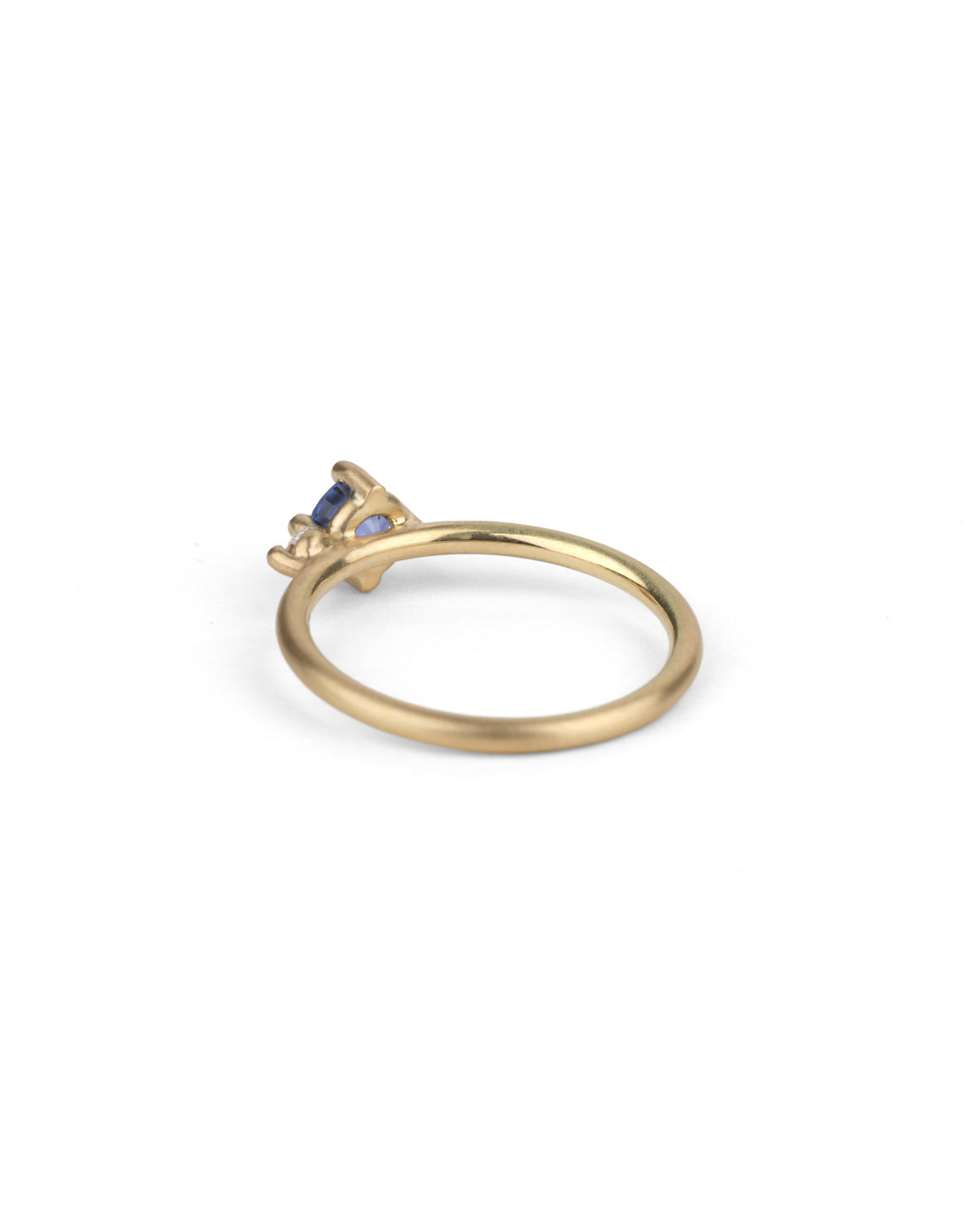 Round vivid blue sapphire ring with a round white diamond. 18ct yellow gold, satin finish. Back view.