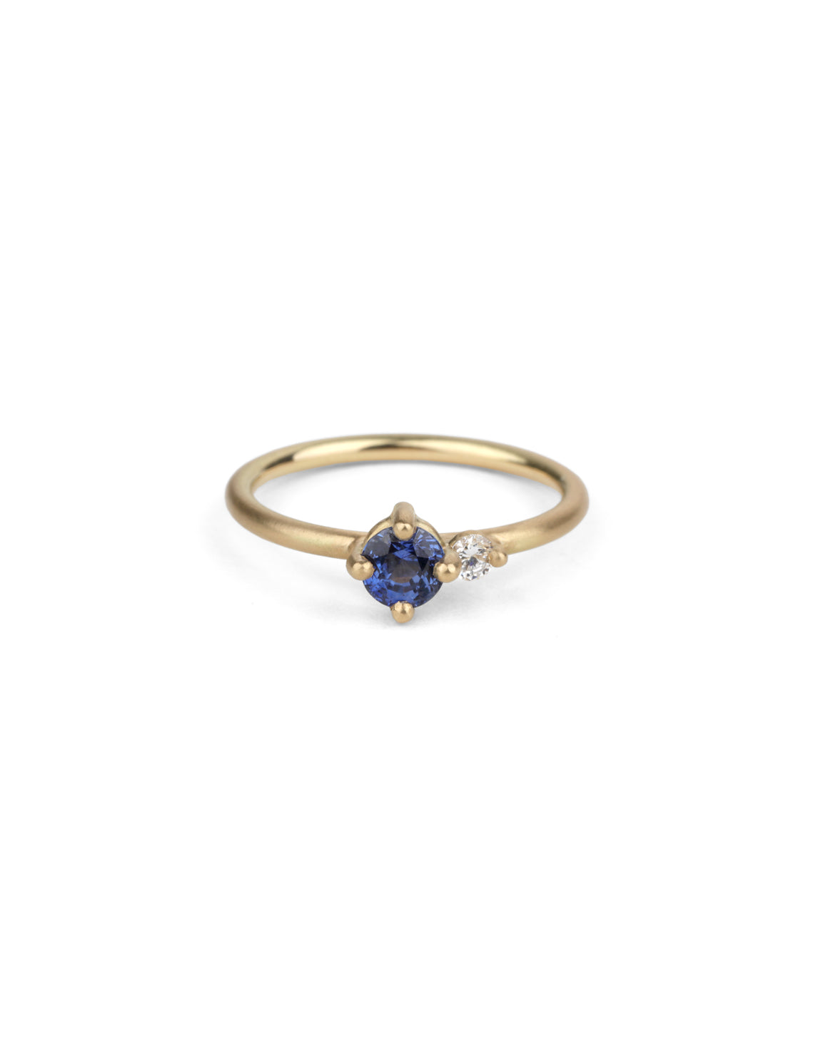 Round vivid blue sapphire ring with a round white diamond. 18ct yellow gold, satin finish.