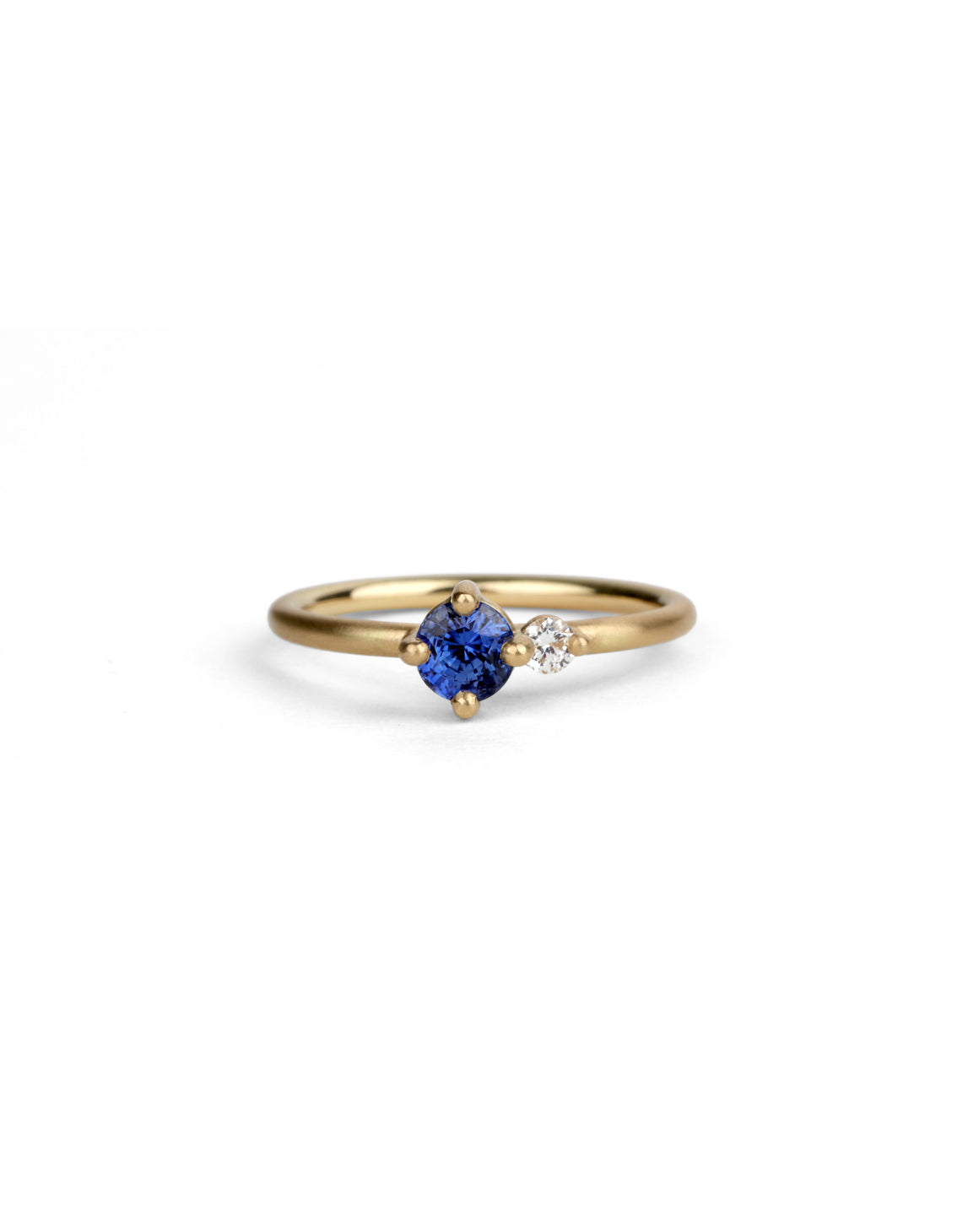 Round vivid blue sapphire ring with a round white diamond. 18ct yellow gold, satin finish.