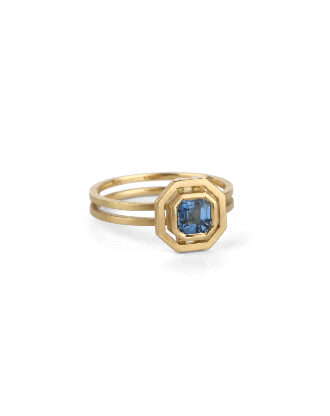Octagon blue sapphire ring with surround detail and double band. 18ct yellow gold with satin finish.