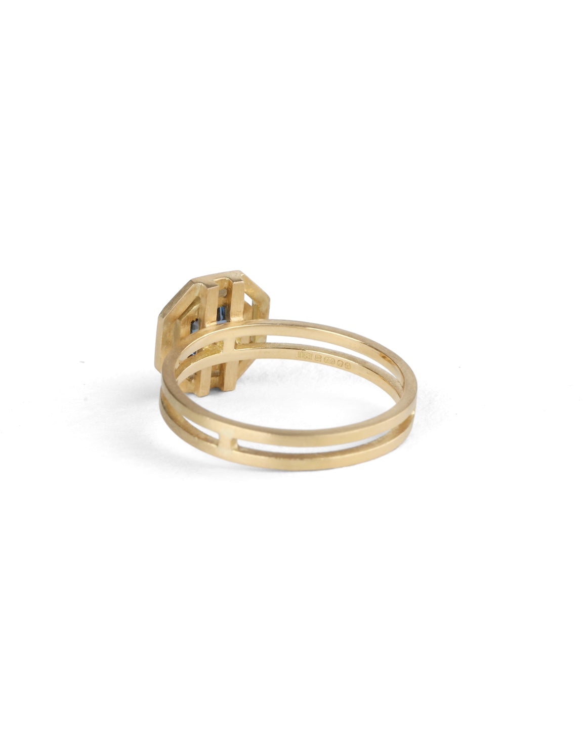 Octagon blue sapphire ring with surround detail and double band. 18ct yellow gold with satin finish. Back detail.