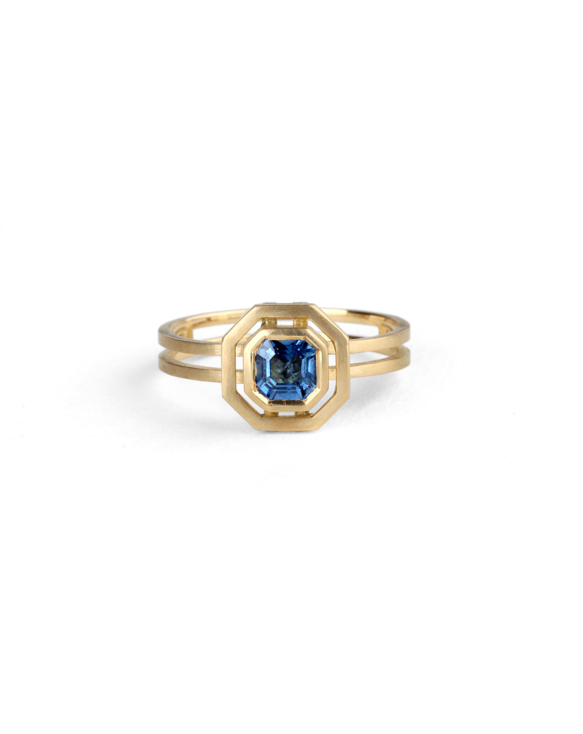 Octagon blue sapphire ring with surround detail and double band. 18ct yellow gold with satin finish.