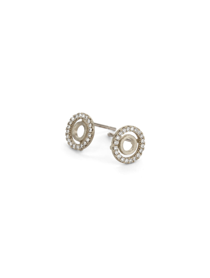 Circular stud earring with tiny diamond detail. 18ct white gold, textured finish.
