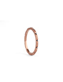 Fine band with set with small dark blue sapphires. 18ct rose gold textured finish.