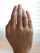 Geometric ring with concentric circle detail, with central diamond, double band. 18ct yellow gold, textured gold. On hand,