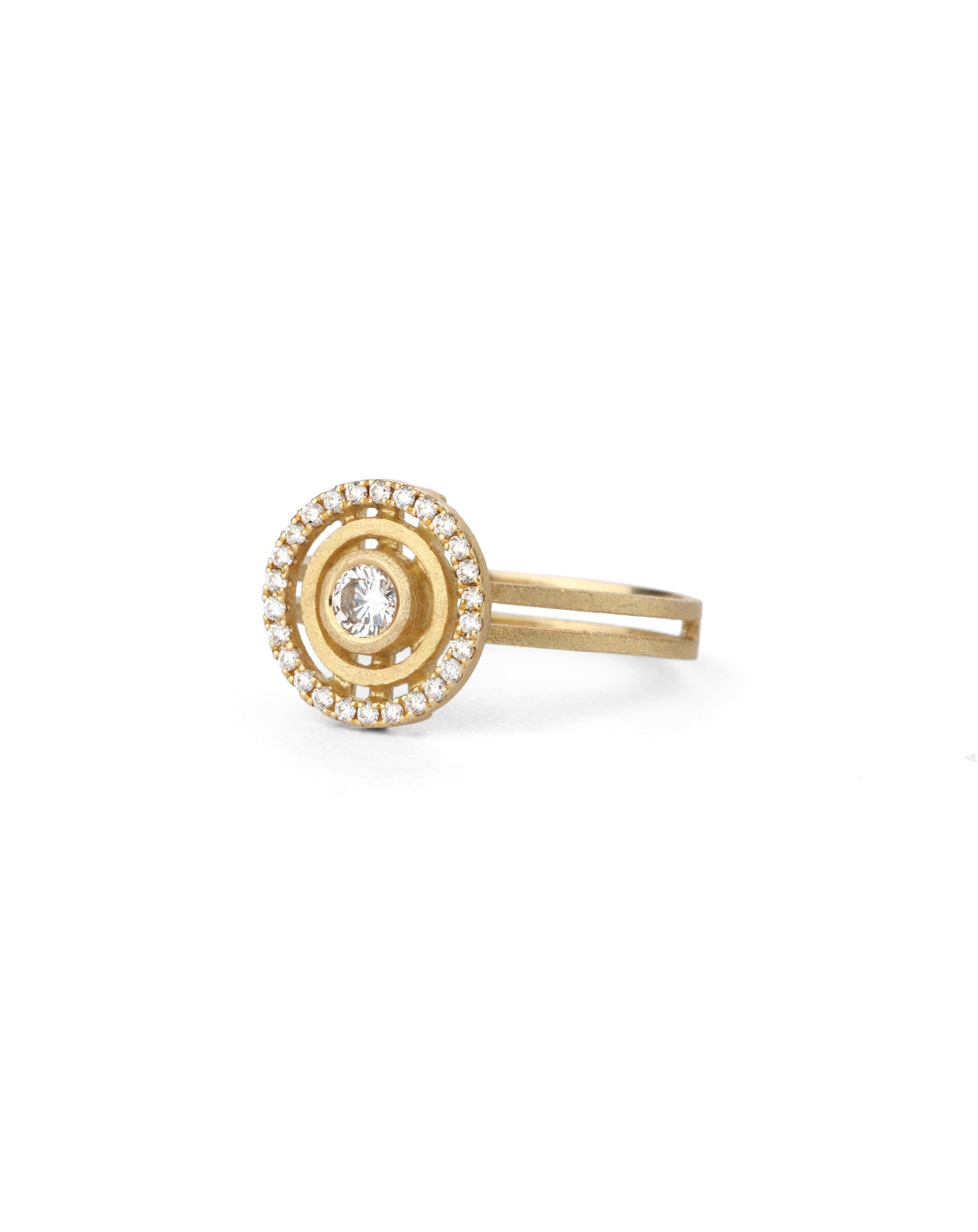 Geometric ring with concentric circular detail, diamond halo and central diamond. 18ct yellow gold textured finish.