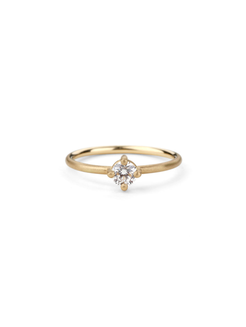 Solitaire ring with round white diamond, four claw setting. 18ct yellow gold, satin finish.