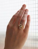 Six diamond wide band ring. Asymmetric configuration on spiral band, 18ct yellow gold textured finish. On hand.