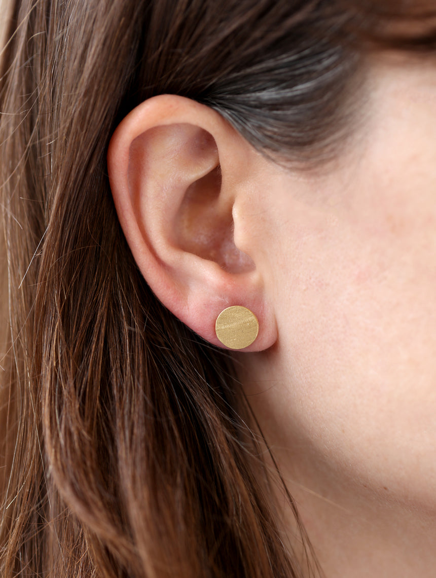 Full circle studs, textured 18ct yellow gold. On ear.