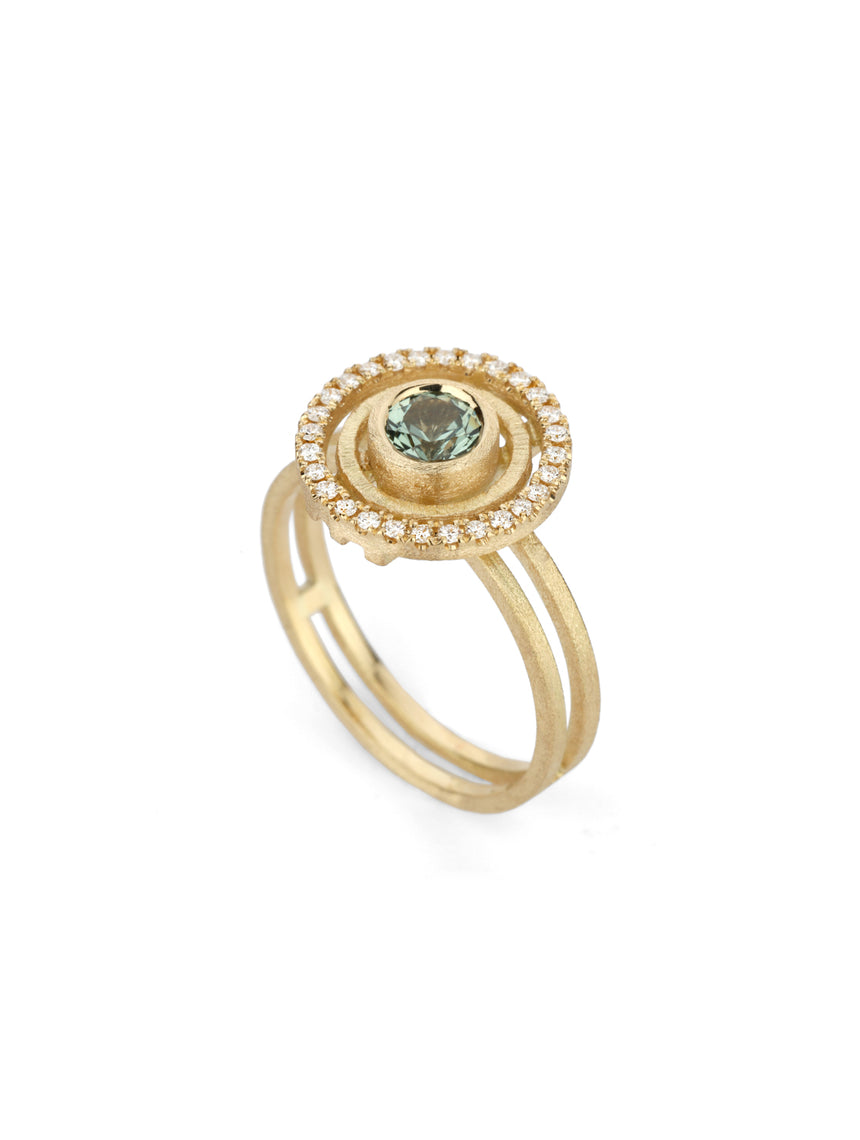 Green sapphire ring with circular detail and white diamond outer halo.  18ct yellow gold, textured finish.