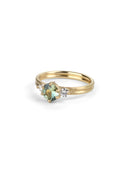 Three stone ring with green sapphire and white diamonds. Joined double band, 18ct yellow gold satin finish. 