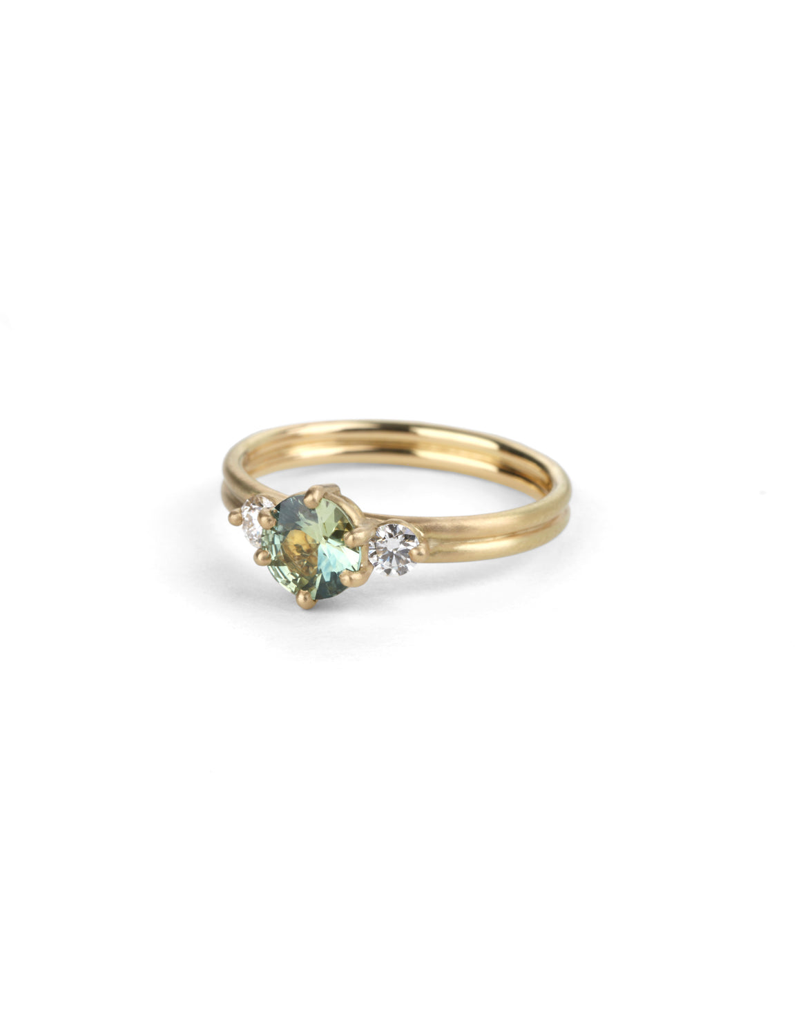 Three stone ring with green sapphire and white diamonds. Joined double band, 18ct yellow gold satin finish. 