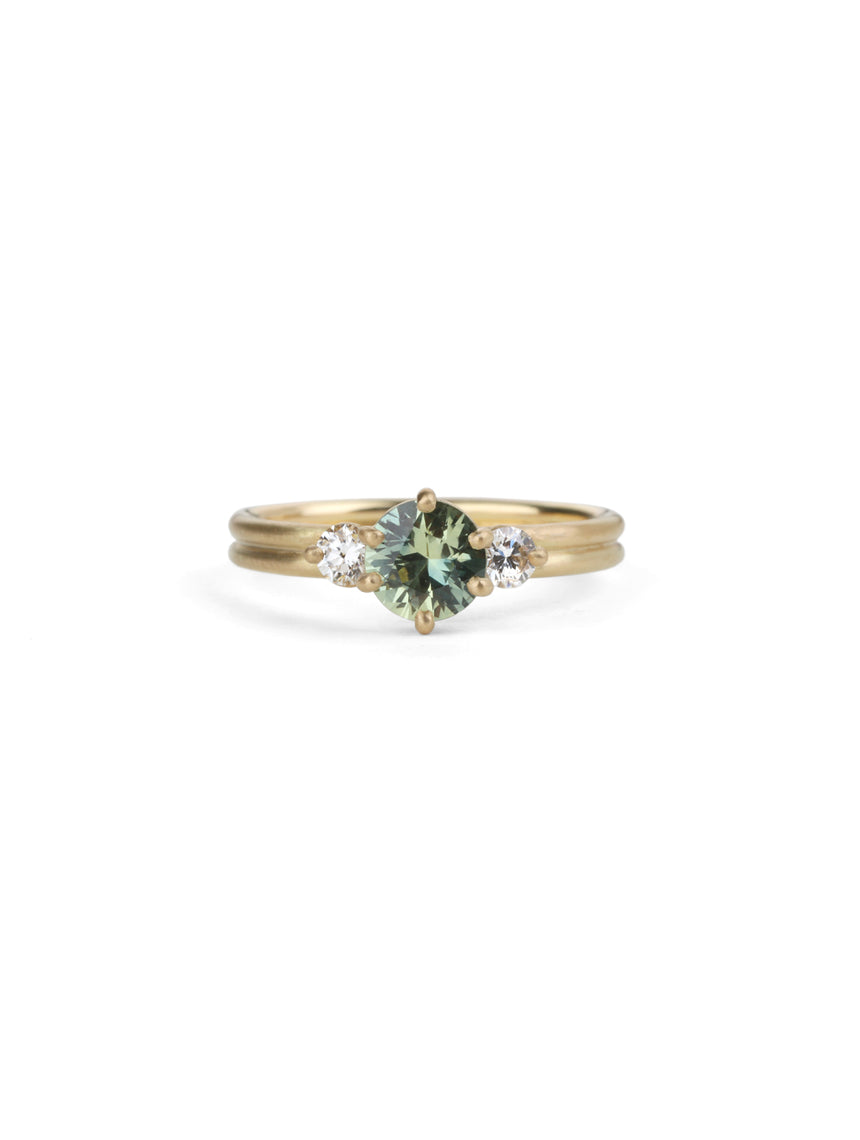 Three stone ring with green sapphire and white diamonds. Joined double band, 18ct yellow gold satin finish. 