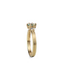Three stone ring with green sapphire and white diamonds. Joined double band, 18ct yellow gold satin finish. Side view.