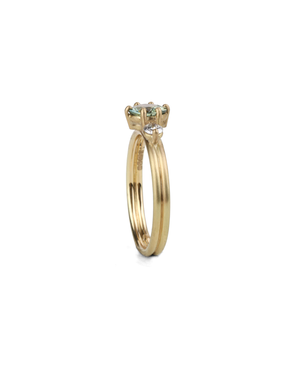 Three stone ring with green sapphire and white diamonds. Joined double band, 18ct yellow gold satin finish. Side view.