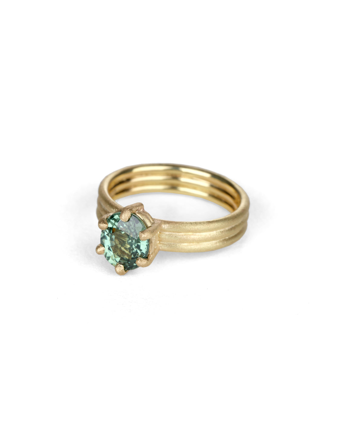 Oval green sapphire ring with six claw setting. On joined triple band, 18t yellow gold, textured finish. 