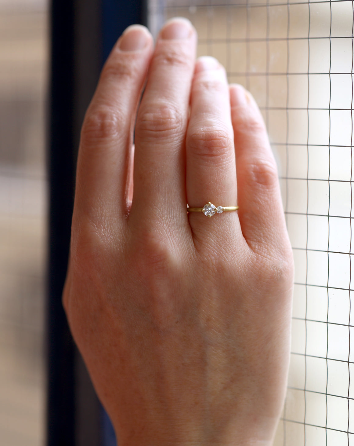 Two stone diamond ring. 18ct yellow gold, satin finish. Worn on hand.