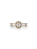 Geometric ring with circular detail and central diamond and double band. 18ct white gold, textured finish.