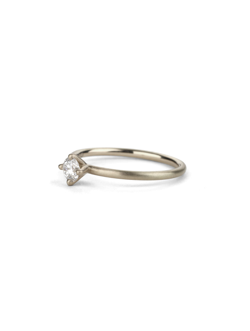 Solitaire ring with round white diamond, four claw setting. 18ct white gold, satin finish.