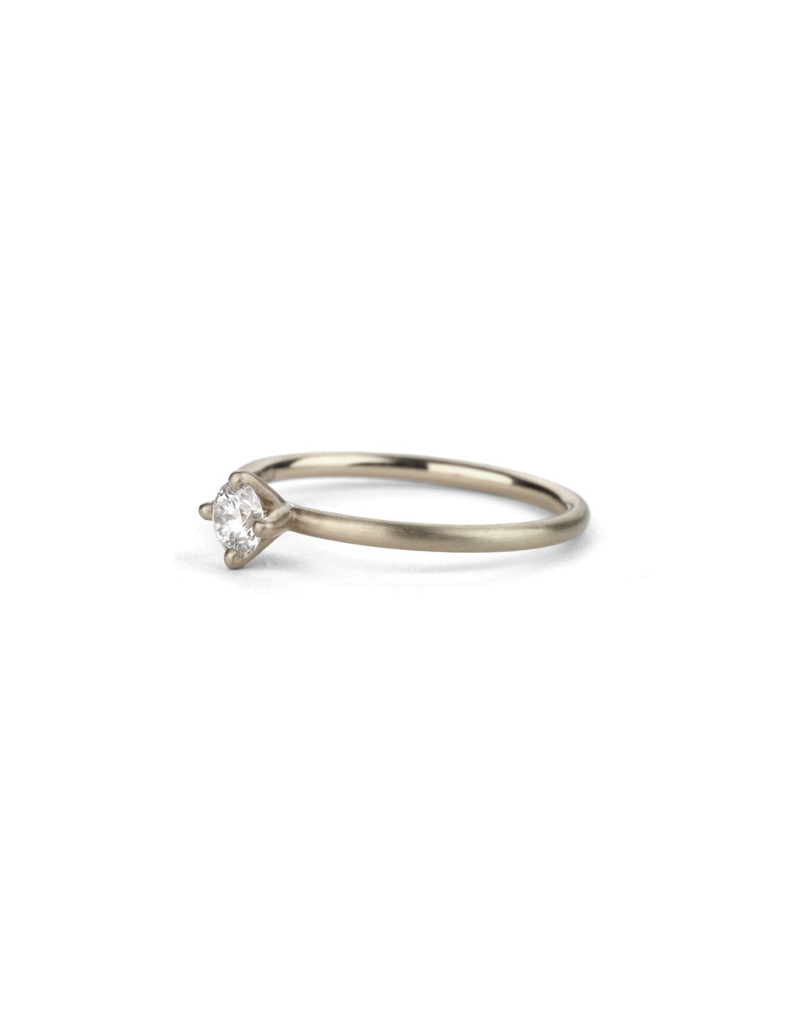 Solitaire ring with round white diamond, four claw setting. 18ct white gold, satin finish.