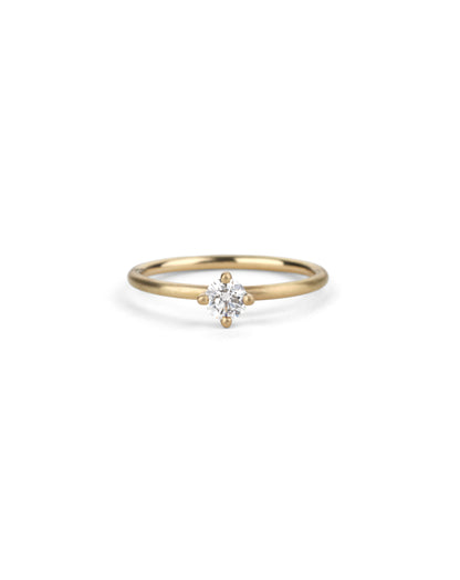 Solitaire ring with round white diamond, four claw setting. 18ct yellow gold, satin finish.