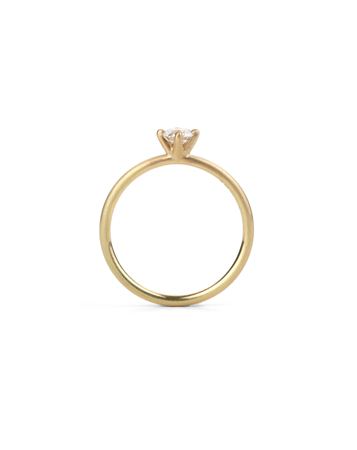 Solitaire ring with round white diamond, four claw setting. 18ct yellow gold, satin finish. Side view.