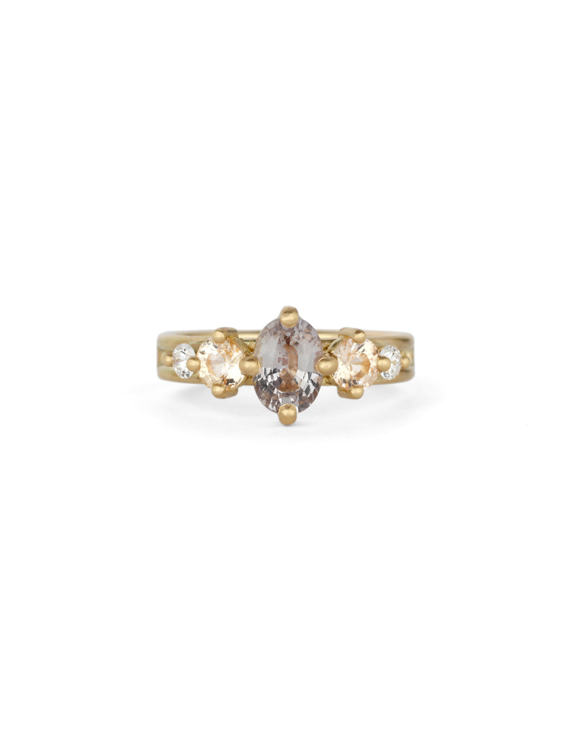Five stone ring with grey oval sapphire, two peach sapphires and two white diamonds. 18ct yellow gold, satin finish.