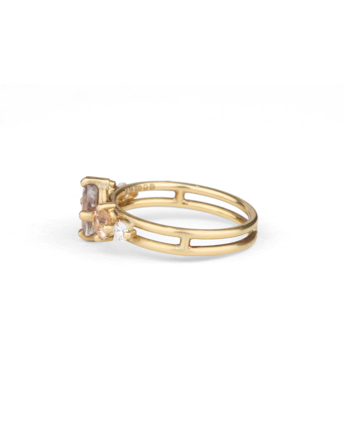 Five stone ring with grey oval sapphire, two peach sapphires and two white diamonds. 18ct yellow gold, satin finish. Side view.