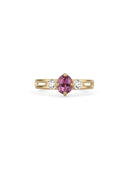 Three stone ring with a pink oval sapphire and two white diamonds. 18ct yellow gold, satin finish.