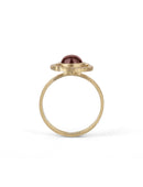 Geometric ring with red garnet and two orange sapphires and a diamond circular surround. 18ct yellow gold, textured finish. Side view.