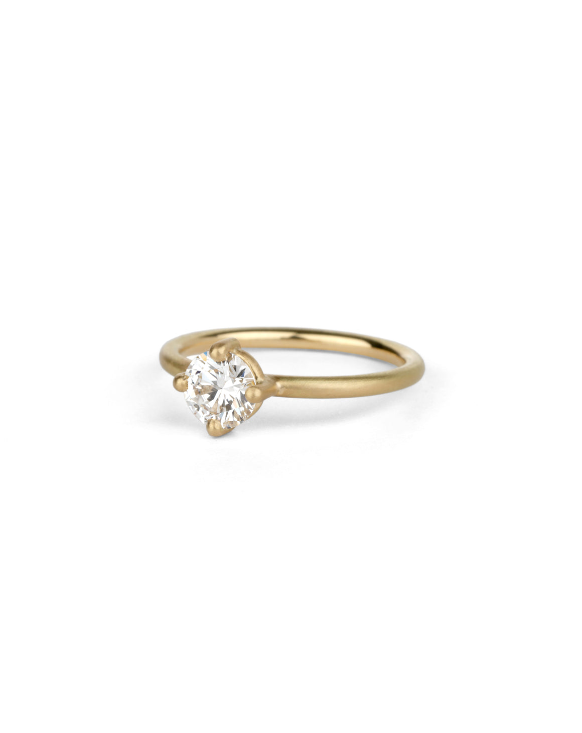 Solitaire ring with round white diamond, four claw setting. 18ct yellow gold, satin finish.