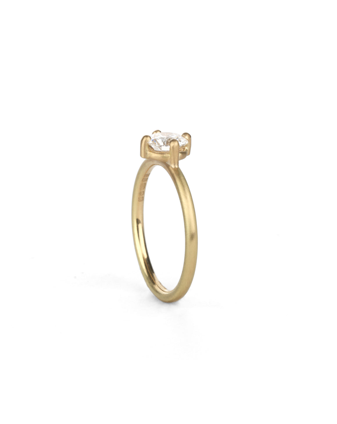 Solitaire ring with round white diamond, four claw setting. 18ct yellow gold, satin finish.