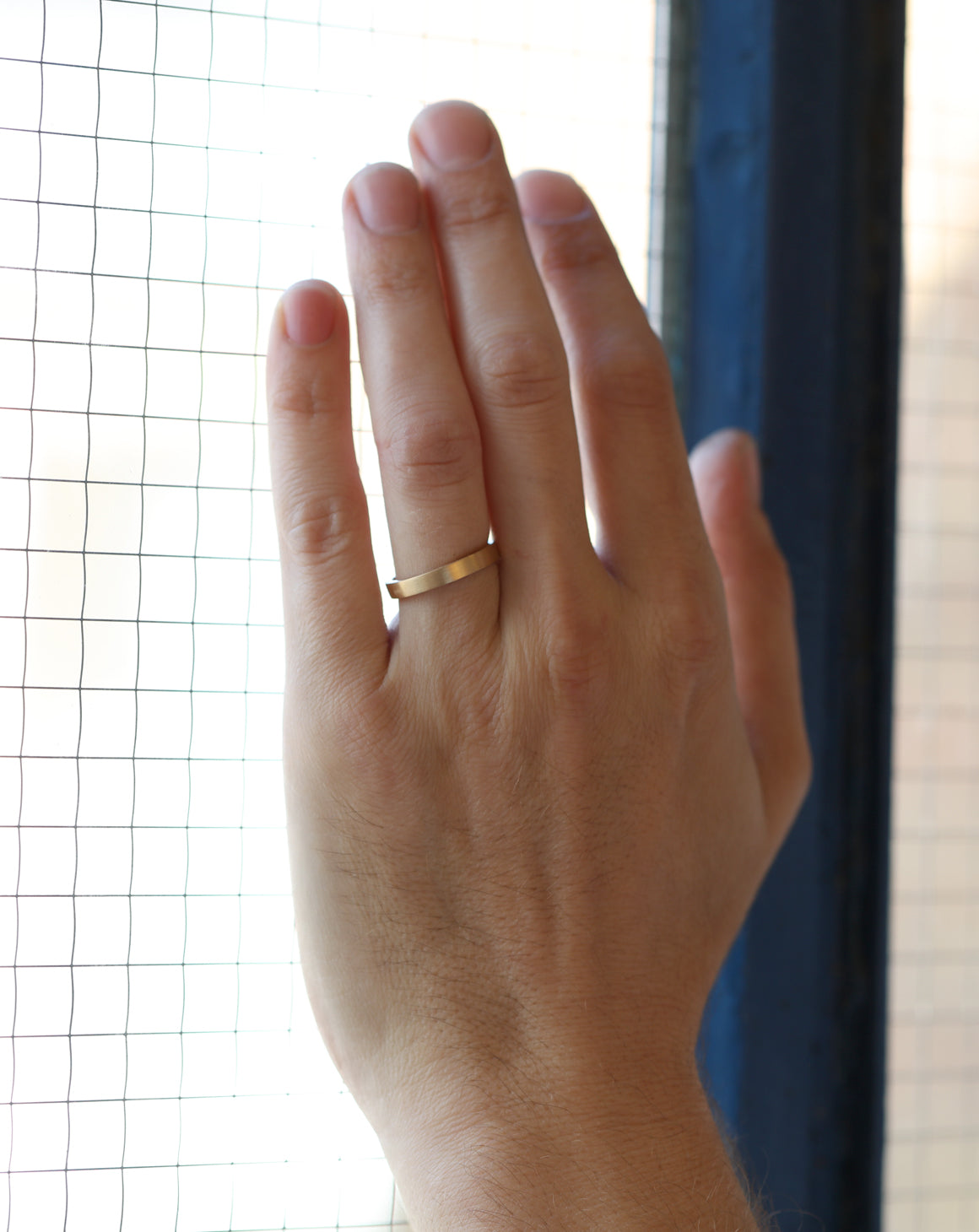 Flat wedding band. 18ct yellow gold, satin finish. On hand.