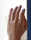 Flat wedding band. 18ct yellow gold, satin finish. On hand.