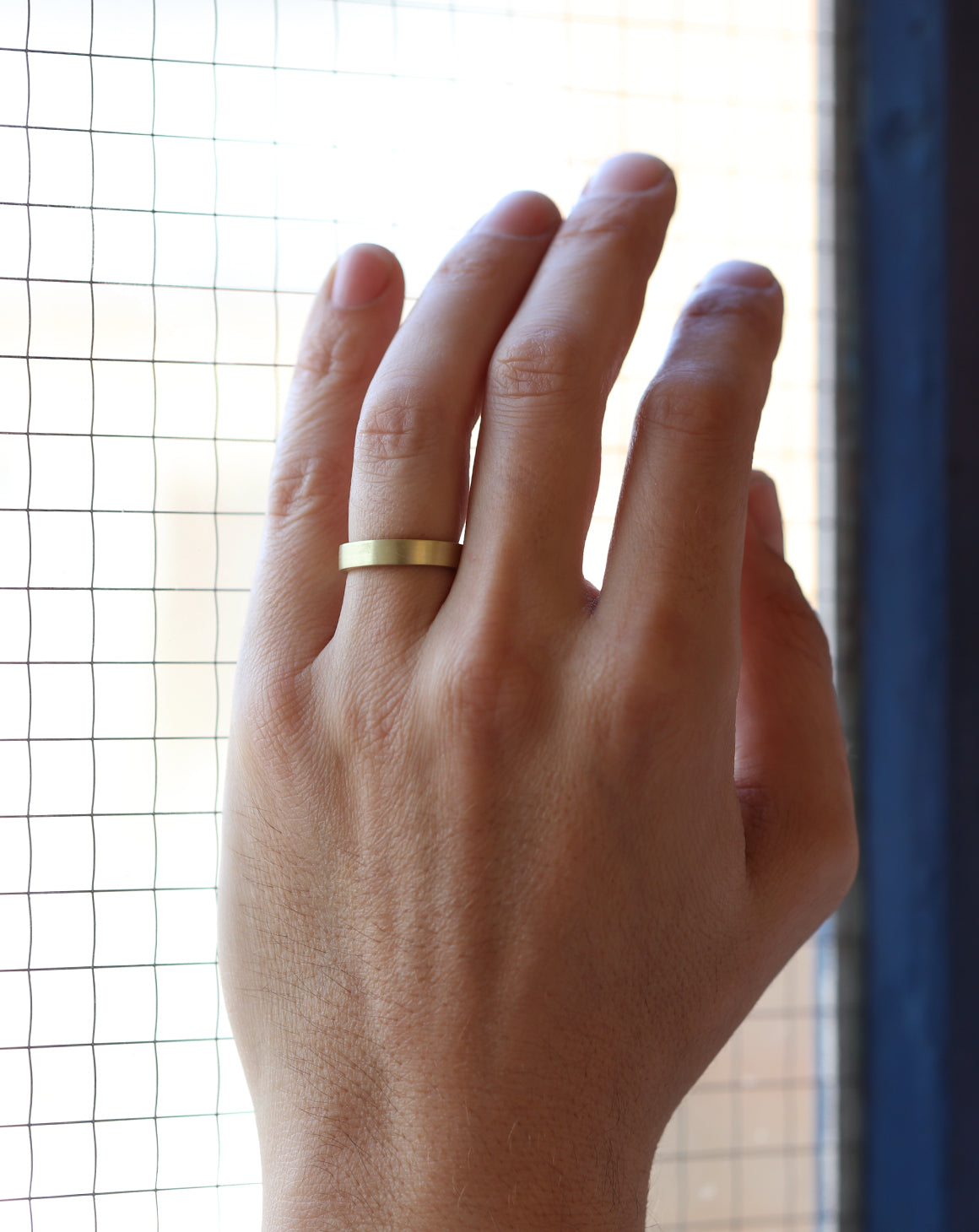 Flat wedding band. 18ct yellow gold, satin finish. On hand.