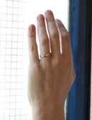 Flat wedding band. 18ct yellow gold, satin finish. On hand.